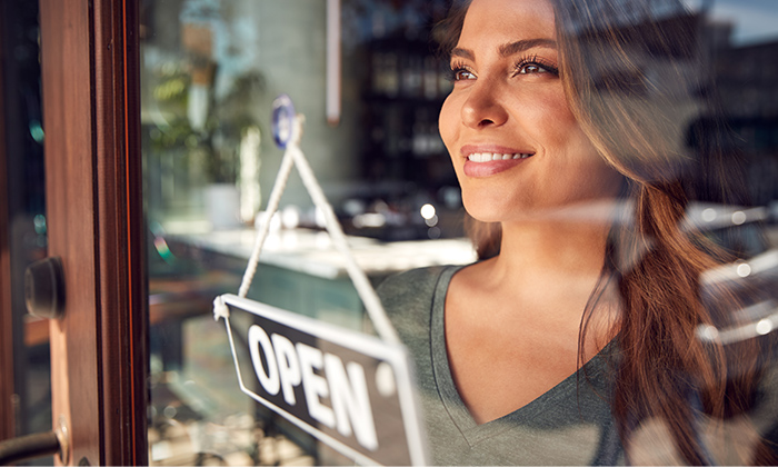 Franchise Owner behind open sign