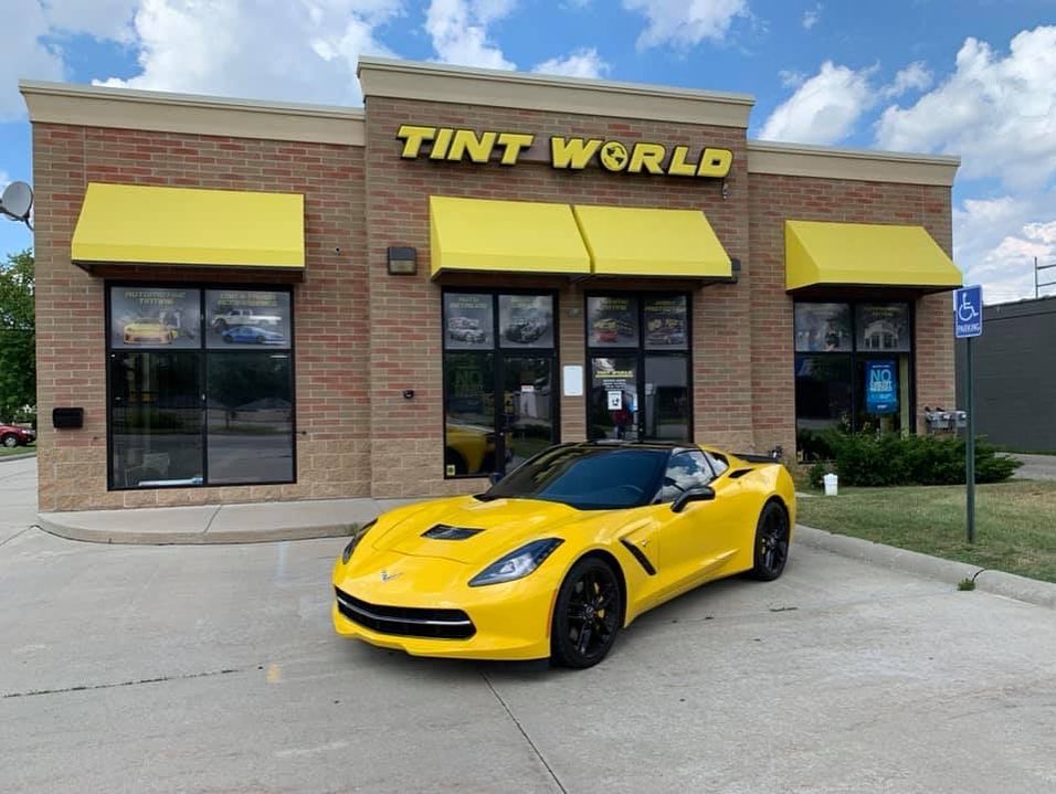 Tint World Location with yellow car on the outside