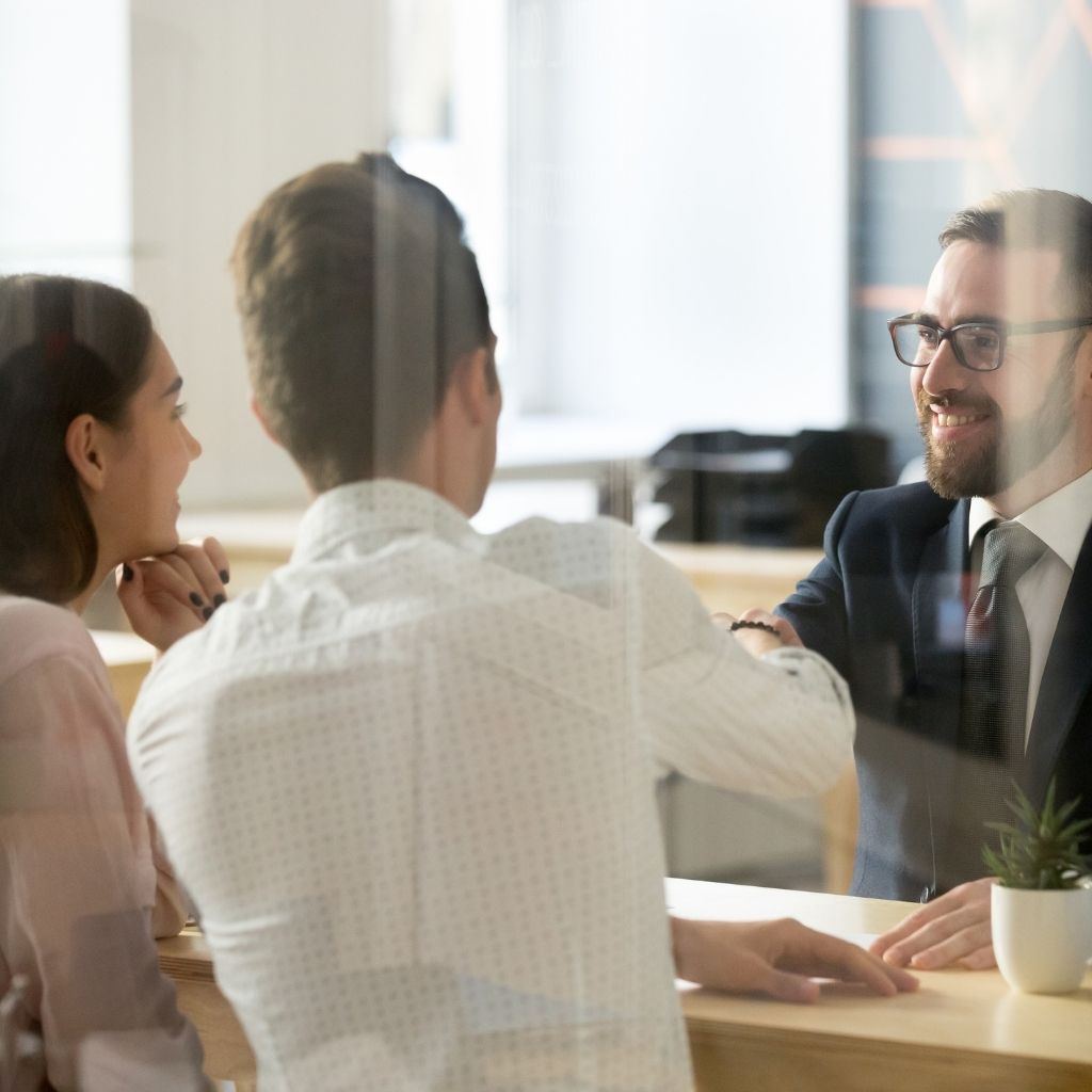 People shaking hands at a desk